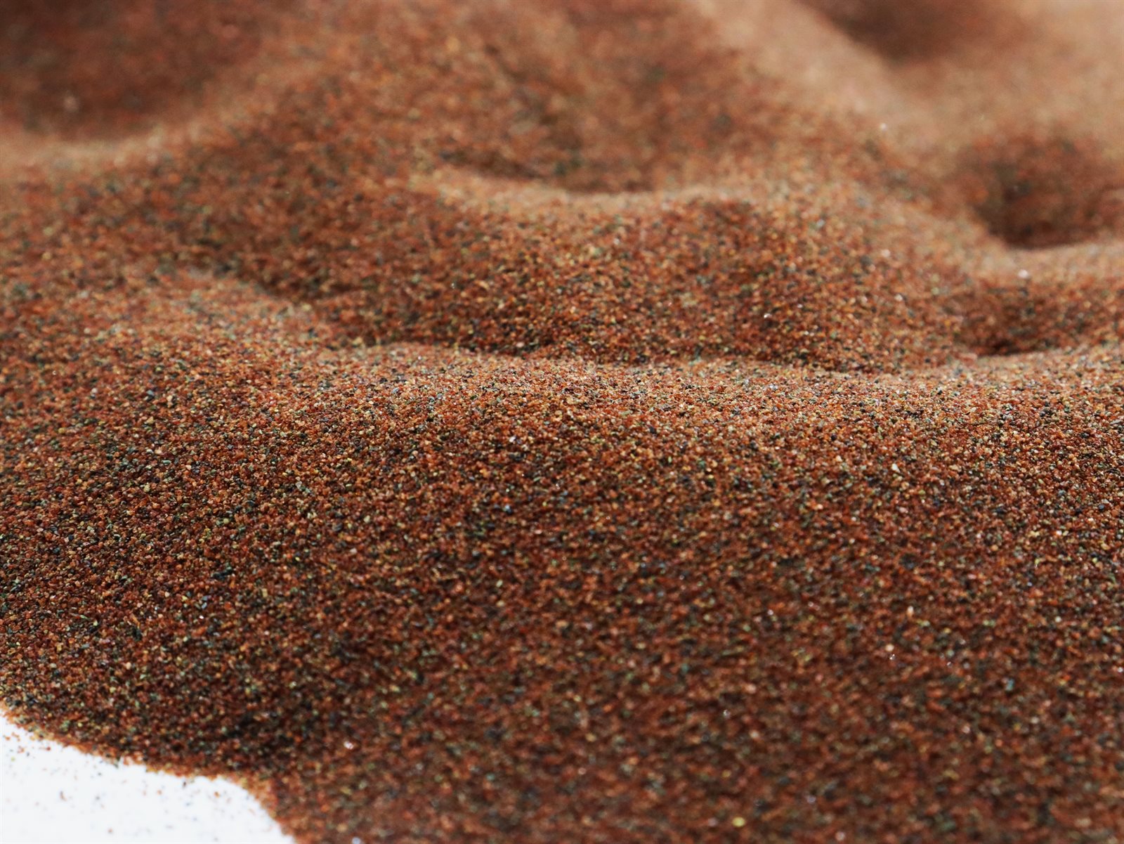 Close-up texture of rock garnet abrasive 80A+ waterjet cutting media